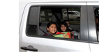 children smiling in car